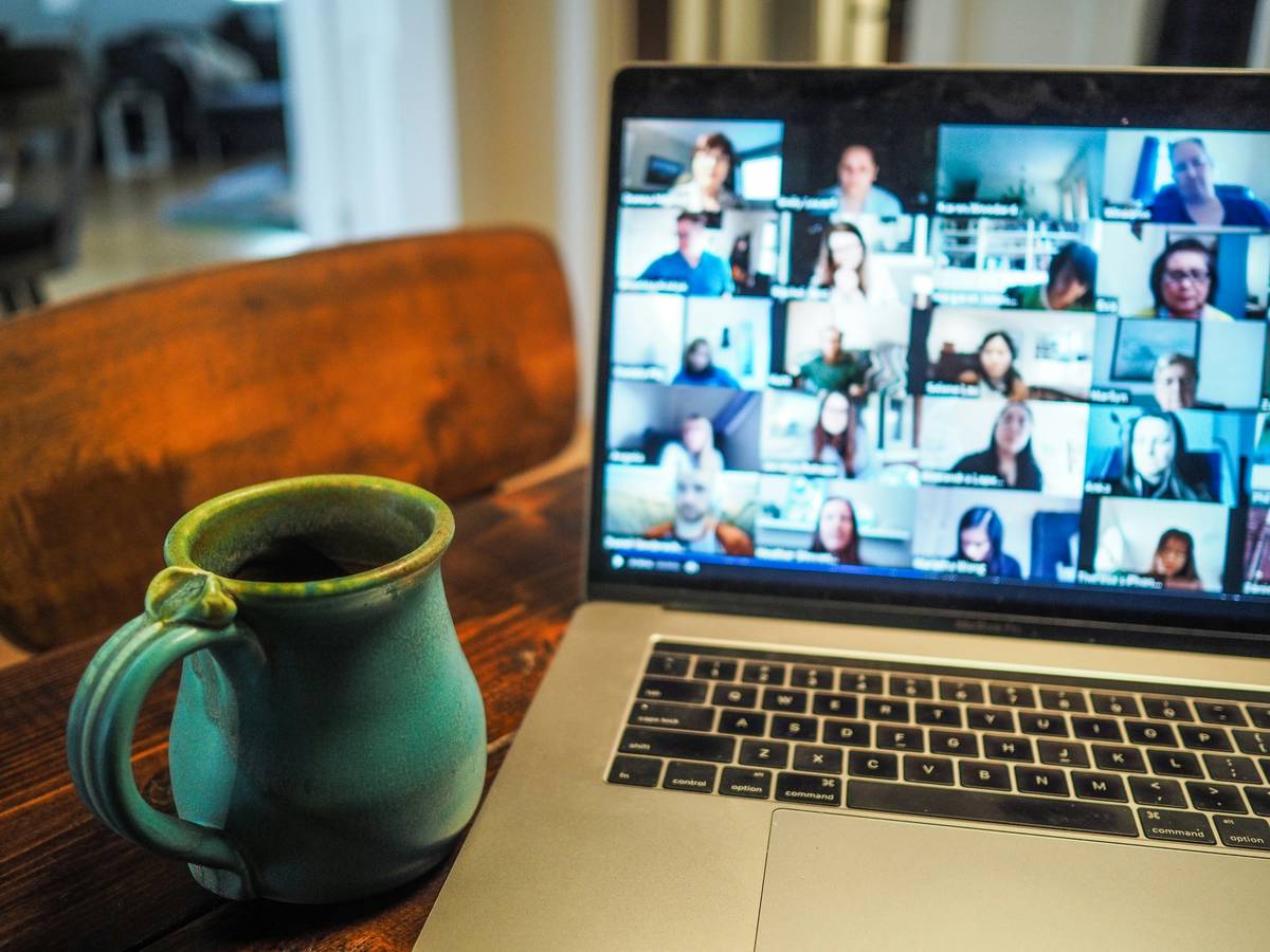 Two professionals smiling during a virtual meeting, illustrating networking skills examples for introverts